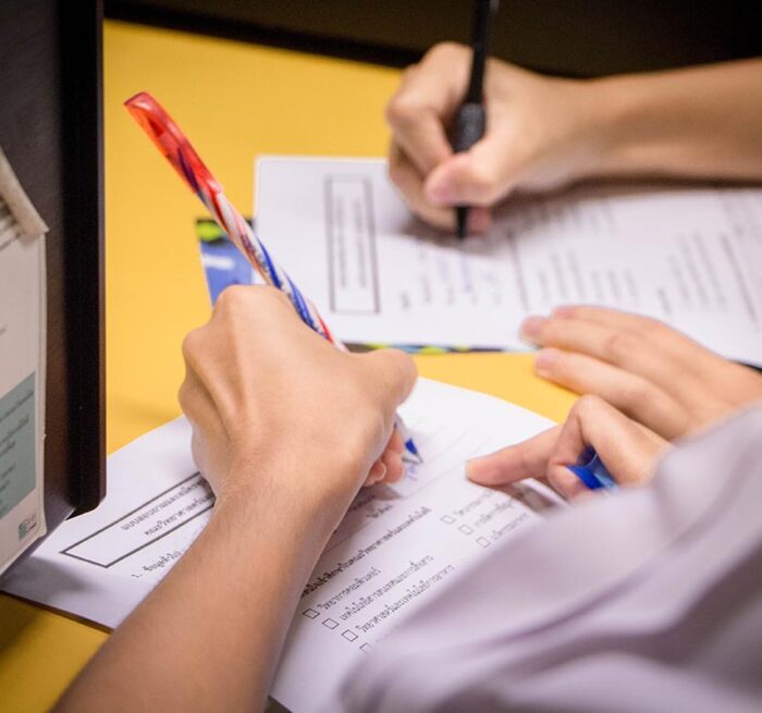 Two people writing on papers